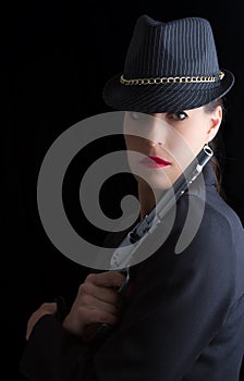 Dangerous woman in black with silver handgun