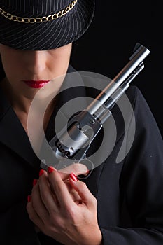 Dangerous woman in black with silver handgun