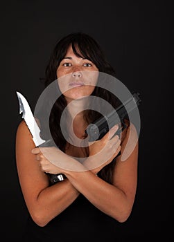 Dangerous woman holding knife and gun