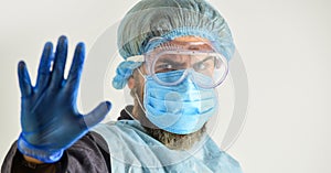 Dangerous zone. Stop. Personal protective equipment. Man wearing protective mask. Coronavirus pandemic. Garments protect