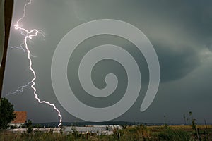 Dangerously close daytime lightningbolt hits the earth in the Mures valley in Transylvania, Romania