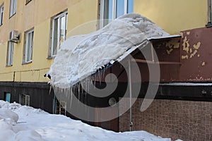 The dangerously overhanging protective canopy of the roof over the Windows buckled under the weight of the snow broke