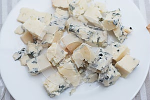 Danish Blue cheese cutted cubes in White Plate Isoalted Clsoe up