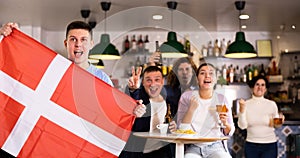 Danish fans scream with joy in beer bar. Denmark win