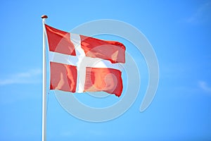 Danish flag with blue sky on background