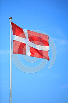 Danish flag with blue sky on background