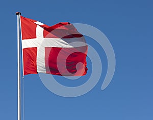 The Danish flag, Dannebrog, against a blue sky photo
