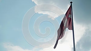 Danish flag flying under cloudy skies