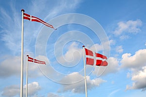 Danish flags Dannebrog in the wind at beach near Copenhagen, National symbol for the country of Denmark photo