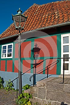 Danish townhouse with street lantern and its shadow photo