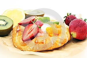 Danish pastry with strawberry, kiwi and tangarine photo