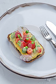 Danish smorrebrod with gravlax and omelet on rye bread