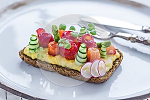 Danish smorrebrod with gravlax and omelet on rye bread photo