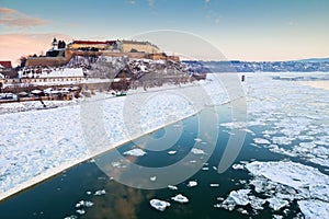 Danube river covered in snow and ice winter time Petrovaradin fortress Novi Sad, Serbia