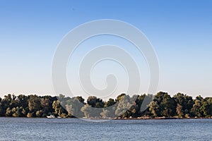 Cargo ship, a barge, cruising on the Danube river in Serbia, in belgrade, carrying construction material, coal, sand and gravel.