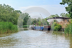 Danube river and view of the small house and barge on a summer day. Vilkovo, Ukraine