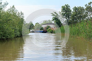 Danube river and view of the small house and barge on a summer day. Vilkovo, Ukraine