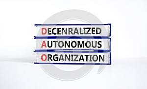 DAO decentralized autonomous organization symbol. Concept words DAO decentralized autonomous organization on books on a beautiful