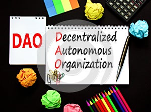 DAO decentralized autonomous organization symbol. Concept words DAO decentralized autonomous organization on white note on a