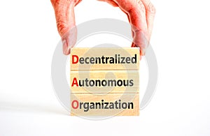 DAO decentralized autonomous organization symbol. Concept words DAO decentralized autonomous organization on wooden blocks on a