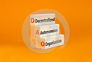 DAO decentralized autonomous organization symbol. Concept words DAO decentralized autonomous organization on wooden blocks on a