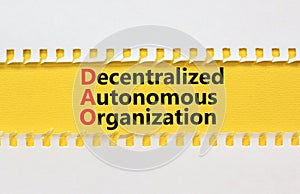 DAO decentralized autonomous organization symbol. Concept words DAO decentralized autonomous organization on yellow paper on a