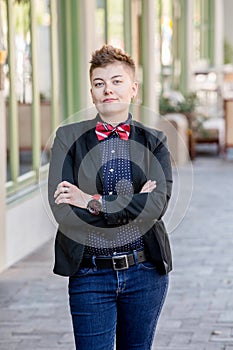 Dapper Gender Fluid Young Woman with Arms Crossed