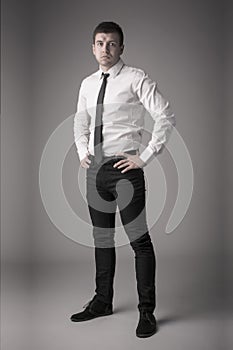 Dapper young business man with hands on hips