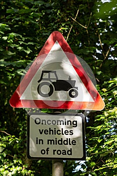 Dappled sunlight on a traffic warning sign