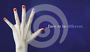 Dare to be different. Originality and creativity concept with blue background. One different nail color in finger. photo