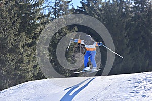 Daring 10-Year-Old Skier Catching Big Air in a Snowy Mountain Landscape