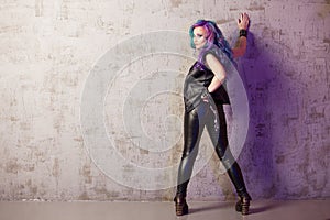 Daring rebel rocker, a portrait on a background of gray grunge wall.