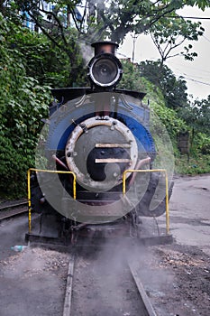 DARJEELING, INDIAN -June 22, The toy train of Darjeeling Himalayan Railway runs on the track in Darjeeling, India. Darjeeling