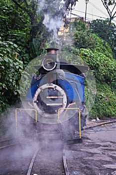 DARJEELING, INDIAN -June 22, The toy train of Darjeeling Himalayan Railway runs on the track in Darjeeling, India. Darjeeling