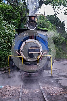 DARJEELING, INDIAN -June 22, The toy train of Darjeeling Himalayan Railway runs on the track in Darjeeling, India. Darjeeling