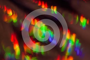 Dark abstract background with overflow, multicolored, rainbow bokeh and highlights.