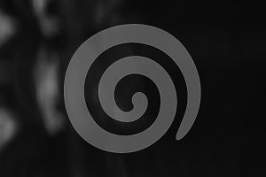 Dark abstract scene with scattered faint reflections.