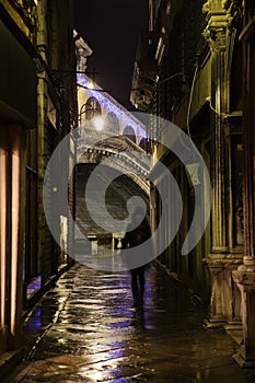 Dark alley in Venice with a silhouette of a woman