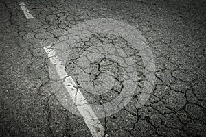 Dark asphalt road with cracks. Background texture