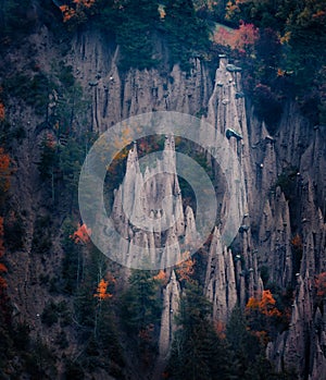 Dark autumn scene of Earth pyramids of Platten - Spiky sand towers