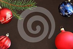 Dark background with Christmas fir branch, red wavy dull, blue ball