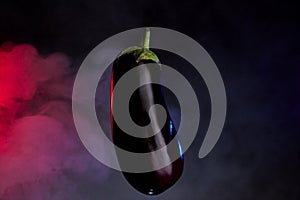 Dark background eggplant photograph with colored light