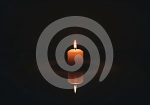 Dark background emphasizes the candle's light, casting a soft