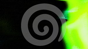 Dark background with a laser ring. Motion. Green and purple lines of laser beams that move in different directions in