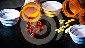 Dark Background with Open Pill bottles and Capsules