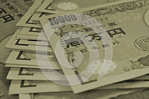 Dark background on the theme of banks, finance and the economy of Japan. Japanese soft money. Tinted green or olive backdrop with