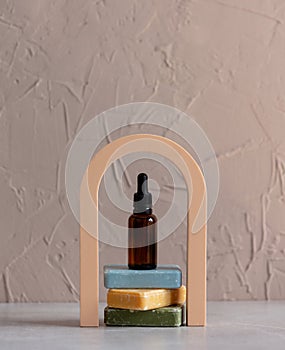 bath bottle and soap on arch decorated background