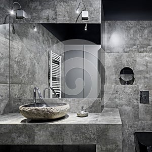 Dark bathroom with gray wall tiles