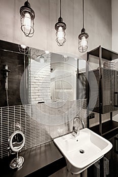 Dark bathroom with industrial style lamps