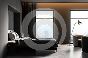 Dark bedroom interior with bed with armchairs on concrete floor near window